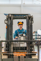 Fototapeta premium Factory worker driving forklift truck to move goods in warehouse of manufacturing plant