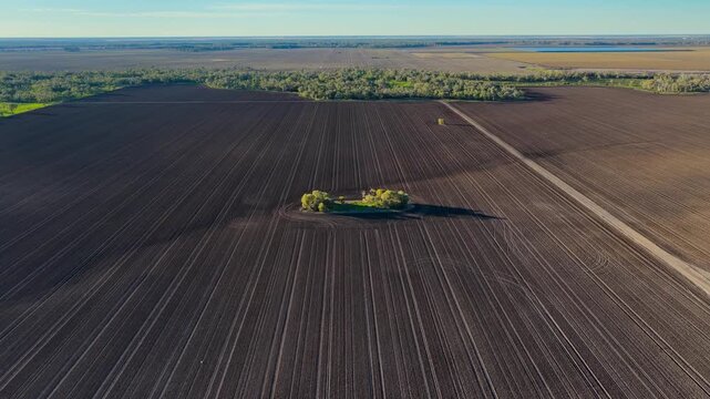 Aerial video flying over cultivated farmland at Pilliga, NSW, Australia. The cultivated soil creates striking natural patterns and textures