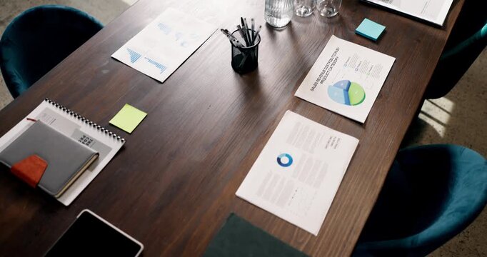 Above, empty and table with documents in office for financial review, analytics and statistics for profit. Background, boardroom and paperwork with graphs, charts and research for finance report