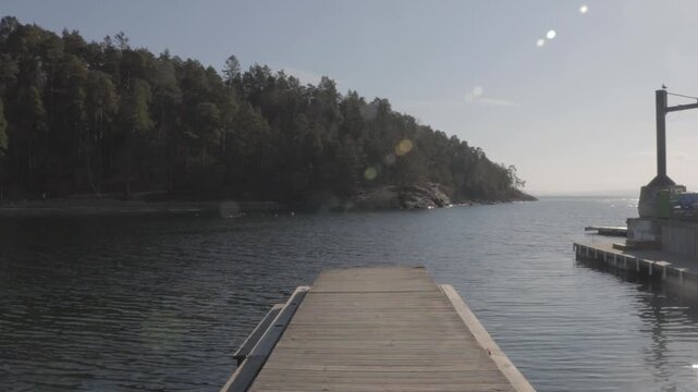 Wooden pier leading into the calm water of the fjord in Bygdoy Oslo