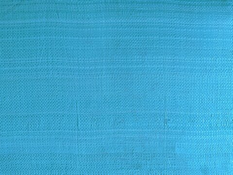 ​Blue woven plastic texture background, closeup light blue polypropylene fabric pattern