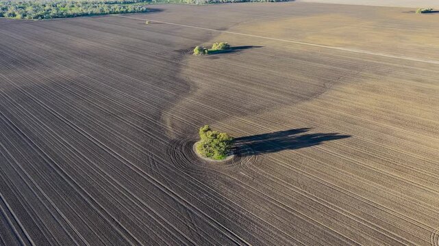 Aerial video flying over cultivated farmland at Pilliga, NSW, Australia. The cultivated soil creates striking natural patterns and textures