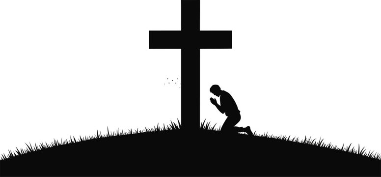 Silhouette of a man kneeling in prayer before a cross on a grassy hill