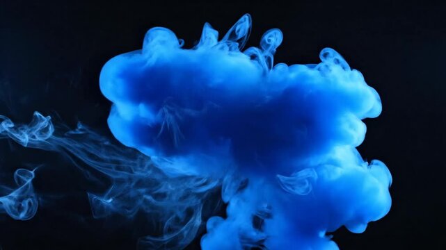 Abstract blue ink cloud swirling in water against a deep black background.