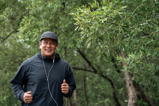 Senior old man runner exercise outdoor nature park. fitness man jogging wearing sportswear. Mature athlete man in sportswear Workout running at public park. Health and activity old man lifestyle