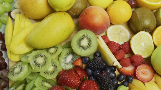 Cluster of colorful, fresh fruit - high, panning shot
