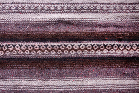 Handmade woven rough pile purple patterned scatter rug background backdrop
