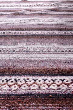Handmade woven rough pile purple patterned scatter rug background backdrop
