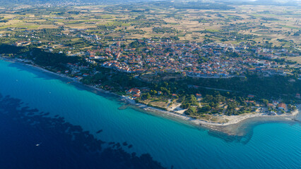 Obraz premium Aerial view of coastal town with blue sea and shoreline