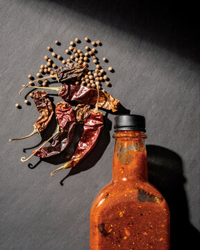 Homemade Hot Sauce Bottle with Dried Chilies and Coriander