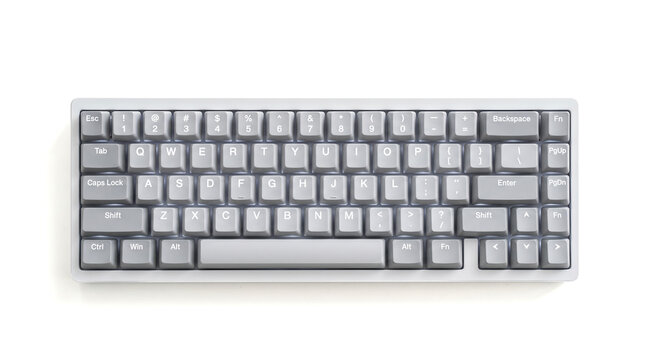 Gray compact mechanical computer keyboard viewed from directly above resting on plain white background representing minimalist modern office desk peripherals