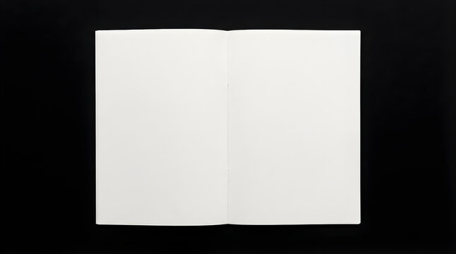 A clean white sheet of paper folded in half against a stark black background, highlighting simplicity and form