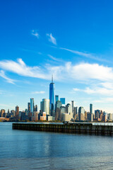 Fototapeta premium New York skyline near harbor. New York cityscape with towers. New York City waterfront and NYC. New York famous district with buildings.