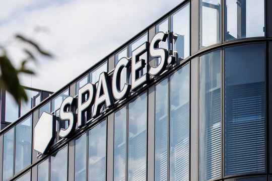 Spaces Logo Displayed on an Office Building in Vienna, Austria. Spaces is an American provider of coworking spaces, flexible offices, and shared workspaces.