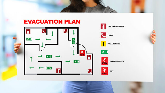 Emergency exit plan shown on sign for safety and evacuation in a building near emergency 911 services