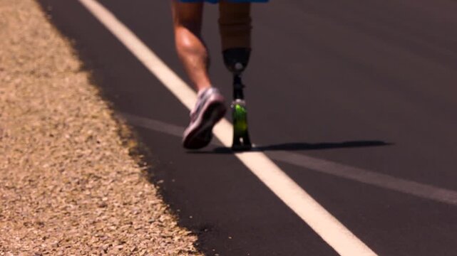 Athlete with prosthetic leg jogging through the badwater marathon