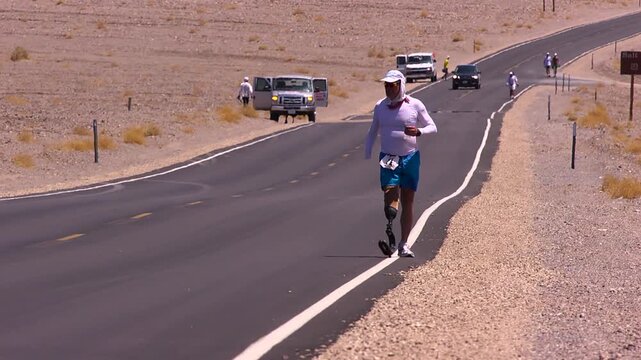 athlete with prosthetic leg suffering in the heat