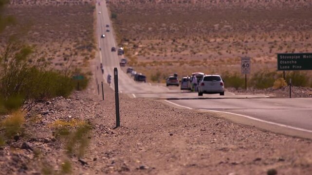 badwater athletes on a long and steep road in death valley