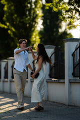 Fototapeta premium Young couple dancing laughing having fun together
