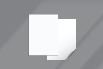 Fototapeta premium Blank white A4 paper sheets and curled page corner mockup on background with elegant organic shadow overlay. Perfect for displaying stationery designs, flyers, posters, branding, Ads and print design