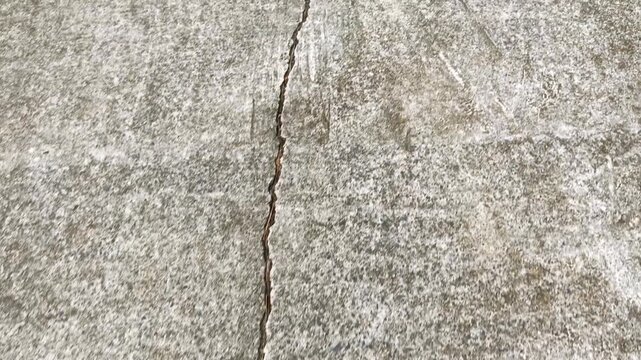 Close up of long crack on concrete ground surface
