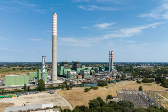 Aerial view of the TTEP Tavazzano thermal power plant and TERNA electrical substation with industrial chimneys and surrounding fields in Tavazzano con Villavesco, Lombardy, Italy.