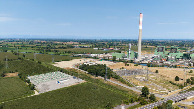 Aerial view of the TTEP Tavazzano thermal power plant and TERNA electrical substation featuring industrial infrastructure and surrounding fields in Tavazzano con Villavesco, Lombardy, Italy.