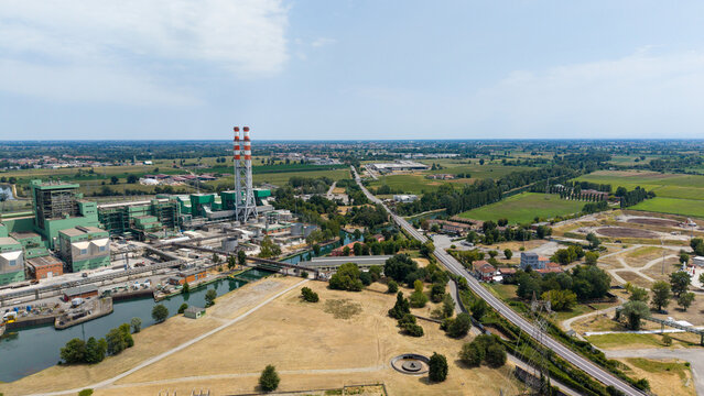 Aerial view of the TTEP Tavazzano thermal power plant and TERNA electrical substation featuring industrial cooling towers and energy infrastructure in Tavazzano con Villavesco, Lombardy, Italy.
