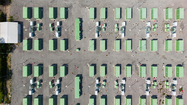 Aerial view of a modern Battery Energy Storage System installation with rows of green containers and electrical infrastructure in Tavazzano con Villavesco, Lombardy, Italy.