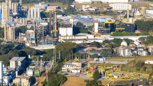 Aerial view of the petrochemical complex featuring industrial towers, storage tanks, and processing facilities surrounded by lush greenery in Santo Andre, State of Sao Paulo, Brazil.