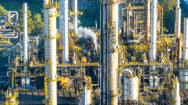 Aerial view of a large petrochemical complex featuring tall industrial towers, intricate piping systems, and steel structures in an urban setting in Santo Andre, State of Sao Paulo, Brazil.