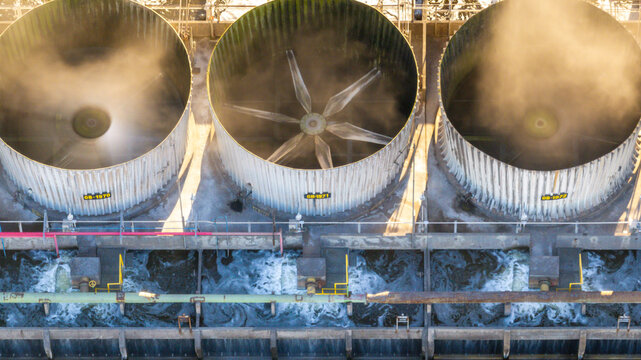 Aerial view of industrial cooling towers at a petrochemical complex with steam rising and water flowing in Santo Andre, State of Sao Paulo, Brazil.