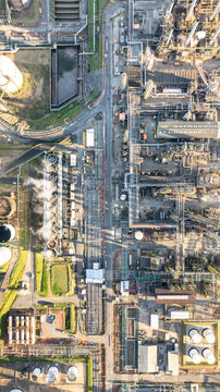 Aerial view of the petrochemical complex in Santo Andre, featuring industrial infrastructure, cooling towers with steam, storage tanks, and pipe networks in Santo Andre, State of Sao Paulo, Brazil.