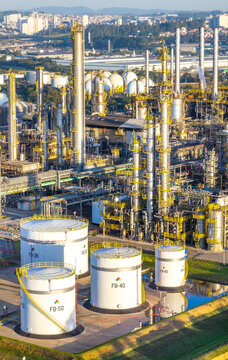Aerial view of the petrochemical complex featuring large storage tanks, industrial distillation towers, and complex piping systems in Santo Andre, Sao Paulo, Brazil.