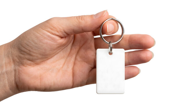 Hand holding blank white keychain tag on transparent background
