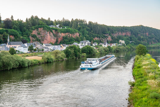 Moselle river in Trier, Germany, important trade route for shipping and viticulture, aerial view to red rocks in Pallien, ship transportation at Mosel valley