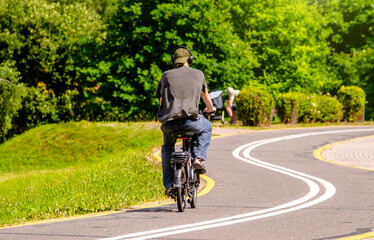 Fototapeta premium Cyclist ride on the bike path in the city Park 