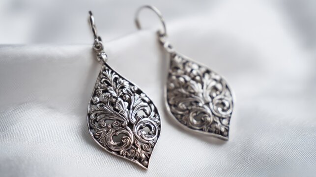 Sophisticated silver filigree earrings with intricate floral pattern isolated on white background, elegant vintage jewelry accessory, handmade ornamental design, luxury fashion earrings for women, cla