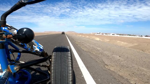 Point of view driving buggy on highway through Paracas desert