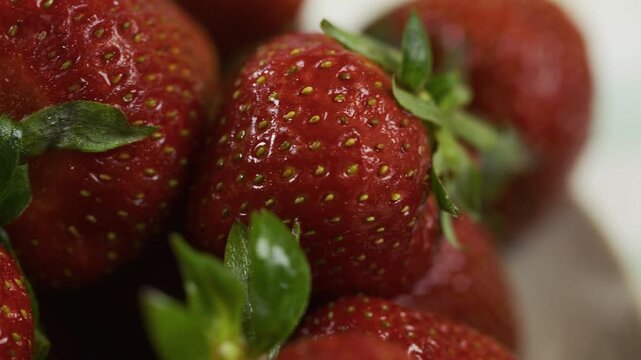 Beautiful cluster of fresh, delicious strawberries - extra closeup, panning shot