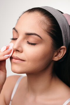 Woman Cleansing Face With Pad