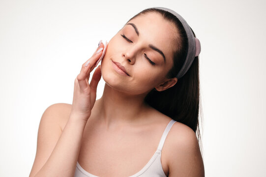 Woman Cleansing Face With Pad