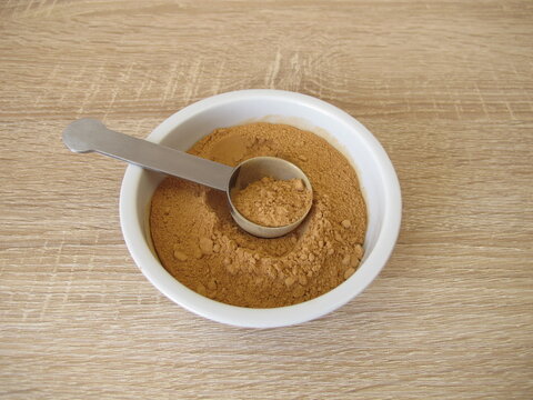 Low-histamine carob powder from the pods of the carob tree in a small porcelain bowl