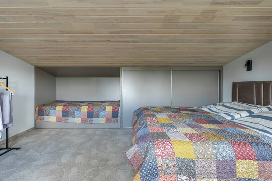 Spacious Bedroom Interior with Multiple Beds and Wardrobe