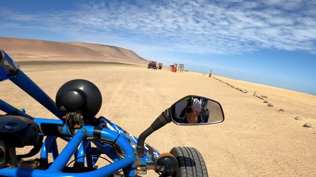 Buggy point of view navigating desert dunes in Paracas Peru
