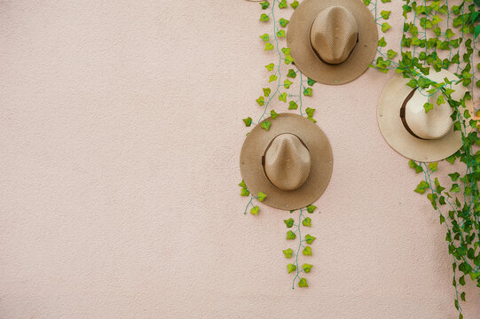 Straw hats decorate textured wall