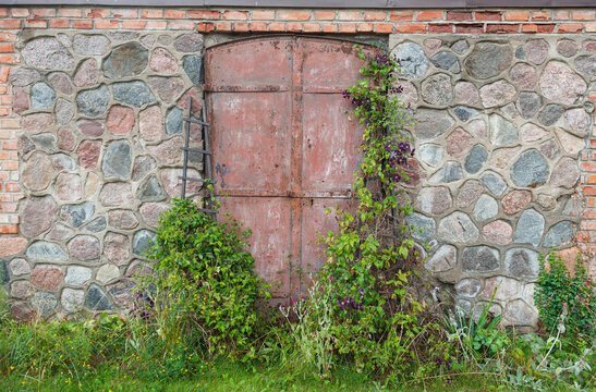 Rustic stone wall frames weathered door