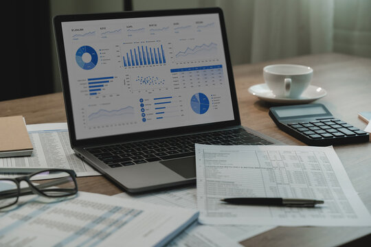 accountant tax refund financial dashboard calculator, printed spreadsheets, pen, eyeglasses, supporting tax refund document review, accounting analysis, financial reporting workflow.
