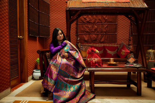 Woman draping her colourful dupatta. 