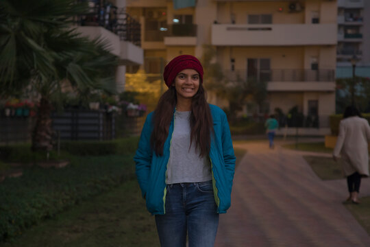 Young girl in winter clothes smiling while walking around. (Children) 